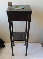 Front view of rare wooden side table showing drawer, lower shelf, tray and holder on top