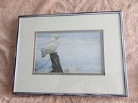 Framed print of a snowy owl by Robert Bateman, showing the entire front of the frame, mat, and artwork.