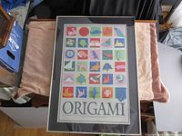 Full view of framed origami poster showing overall condition and mounting.