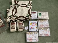 Overview of full set including folded Lenox Holiday Nouveau quilt, packaged sheets from Martex and Penna West, and shams.