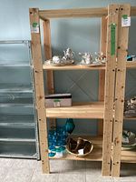 Front view of IKEA wooden shelving unit with four shelves, natural wood finish, showing clear condition and dimensions