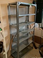 Front view of the metal shelving unit showing six shelves and cross-bracing on back.