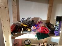 Shelf with brushes, scrapers, rags, and car care spray can