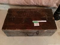 Top and front view of the vintage wooden tool box showing rectangular shape, dark brown finish, metal handle and latch.