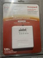 Front view of the Honeywell Heat Only Thermostat CT33A sealed in its packaging showing product details and temperature dial.