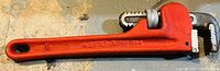 Full view of a red heavy duty pipe wrench, size marking '8' visible on handle end