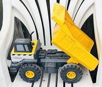 Front angle view of the Tonka 354 dump truck toy with raised yellow dump bed and visible details of the cab and wheels.