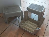 Three used durable plastic step stools on tiled floor. One stool is upside down showing grid underside.