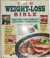 Front cover of the book titled 'The Weight-Loss Bible' featuring colorful text and an image of a healthy meal on a plate.