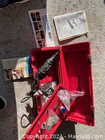 Complete Dremel Model 275 Multi Pro rotary tool set including tool, red case, manuals, and accessories.