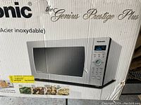 Box of Panasonic Genius Prestige Plus built-in microwave oven showing product image and brand.