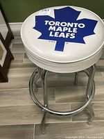 Top view of the padded white seat showing the Toronto Maple Leafs blue maple leaf logo with text in white.