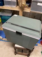Top and front view of the vintage Koolatron electric cooler showing its green textured exterior and black handle.
