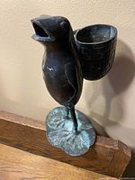 Full view of the bronze frog spill holder standing on a lily pad base with attached brick pattern cup-shaped container.