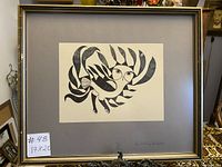 Front view of the framed Inuit printed artwork titled 'Sun Owl' by Kenojuak, showing the complete framed piece with the gray matte and gold frame.