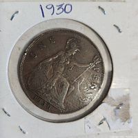 Front side of the 1930 penny coin showing Britannia sitting with trident and shield, year 1930 visible below, housed in a cardboard holder.