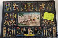 Front cover of the antique photo album with colorful Egyptian motifs including pyramids, camels, and ancient figures.