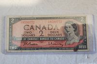 Front view of a 1954 Canadian two dollar bill, displaying text in English and French and a portrait of Queen Elizabeth II.