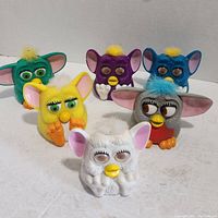 Six McDonalds Furby collectibles arranged together showing their variations in color and design.