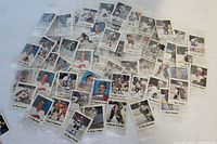 Photo showing spread of multiple mini hockey cards from 1988-89, many still sealed in original packaging, various players shown.