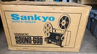 Original cardboard box for Sankyo Sound-600 Super 8 / Single 8 projector showing brand name, model, and illustrative graphics of the projector.