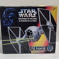 Front of box showing Star Wars The Power of the Force TIE Fighter vehicle with solar panel wings firing lasers.