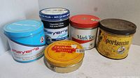 Five vintage tobacco and cigarette tins grouped together displaying various brand names and colors.