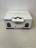 Front view of a white cardboard box labeled 'Staples' containing industrial garbage bags.