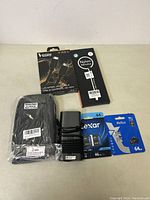 All items displayed including universal HDMI cable, nylon organizer, power adapter, Lexar 64GB SD card, and Netac 64GB microSD card in packaging