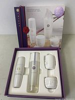 Opened box showing the four skincare items in a foam insert with the box lid showing product image and branding.