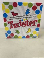 Front of sealed Twister game box featuring colorful dots and logo with handprint and footprint