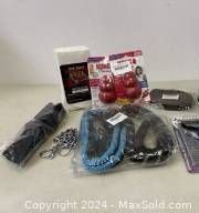 Overview of new pet supplies including KONG toys, leashes, training brick, and collars/harnesses on table.