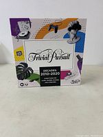 Front and side view of Trivial Pursuit 2010-2020 game box showing colorful graphics and branding.