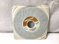 Photo of "United We Stand" 7-inch vinyl single on Deram label with plain paper sleeve showing wear