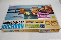 Photo of the Eldon Collect-a-Car Raceway original box showing the toy set layout and promotional text.
