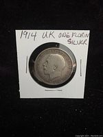 Obverse side of 1914 UK silver one florin coin showing King George V portrait and inscriptions.