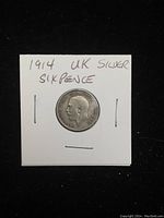 Obverse side of 1914 UK silver sixpence coin showing King George V profile and inscriptions.