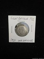 Obverse side of 1921 UK silver one shilling coin showing King George V profile and inscriptions.
