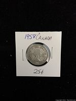 Obverse side of the 1958 Canadian silver quarter showing Queen Elizabeth II profile and year 1958.