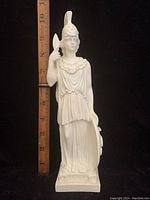 Full view of the white Athena Minerva statue with a ruler beside showing approximate height of 10 inches.