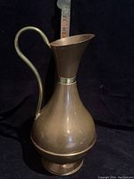 Copper pitcher front view with measuring tape showing height approximately 10 inches
