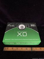 Box of Polara XD Extra Distance golf balls showing front with branding and product features.