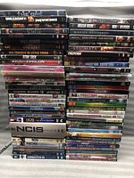 Photo showing stacked DVD movie cases including titles such as Unleashed, Enchanted, The Last King of Scotland, Wall Street II, Big Trouble in Little China, Star Trek, NCIS, and others vertically and horizontally piled.