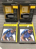 Four Scosche SoundKASE armband cases for new iPod, two visible packages side-by-side.