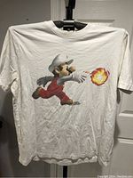 Front view of white vintage T-shirt showing Mario in white outfit throwing fireball.