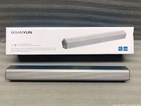 Photo of Sanyun SW010 speaker packaging box showing product image, dimensions, and product branding.