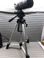 Full view of Soligor telephoto zoom lens mounted on tripod