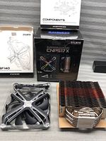 Zalman CNPS17X CPU cooler heatsink, 140mm fan, accessories box, and manuals shown with original packaging for fan and cooler.
