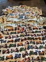 Three novelty men's shirts layered showing patterns of motorcycle and fishing prints.