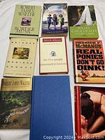 Overview of the nine books in the lot showing front covers and titles